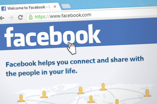 A cursor hovers over the Facebook homepage