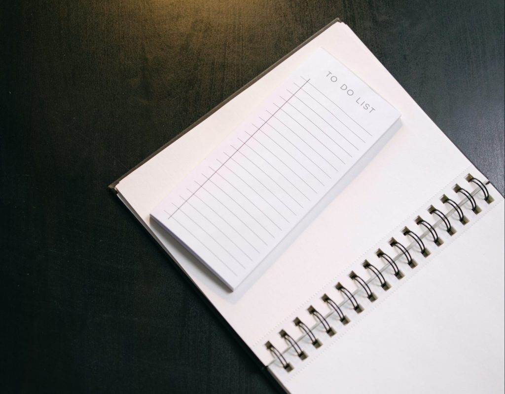 A block of To-Do notes lies on an open notebook