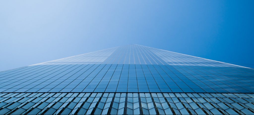 A building rising into the sky and blending in with the blue