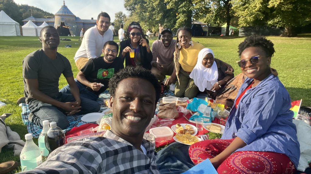 Group selfie with diverse SI scholarship students at KI during a picnic during my first month at KI.