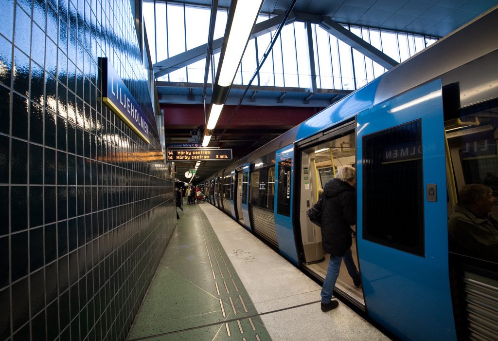 A picture of an underground train and a person boarding - showing the personal Swedish culture.