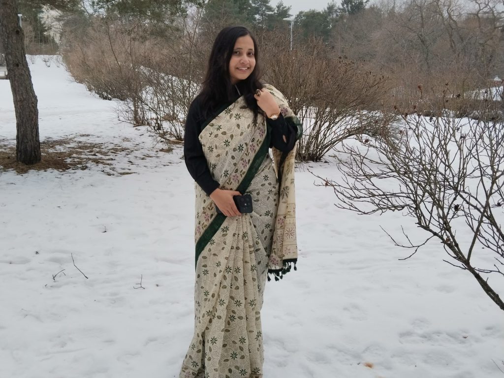 Woman dressed in a sari standing in a snow landscape