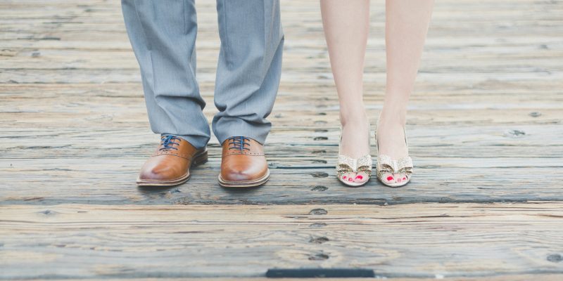 Picture of lower legs of couples standing side by side.