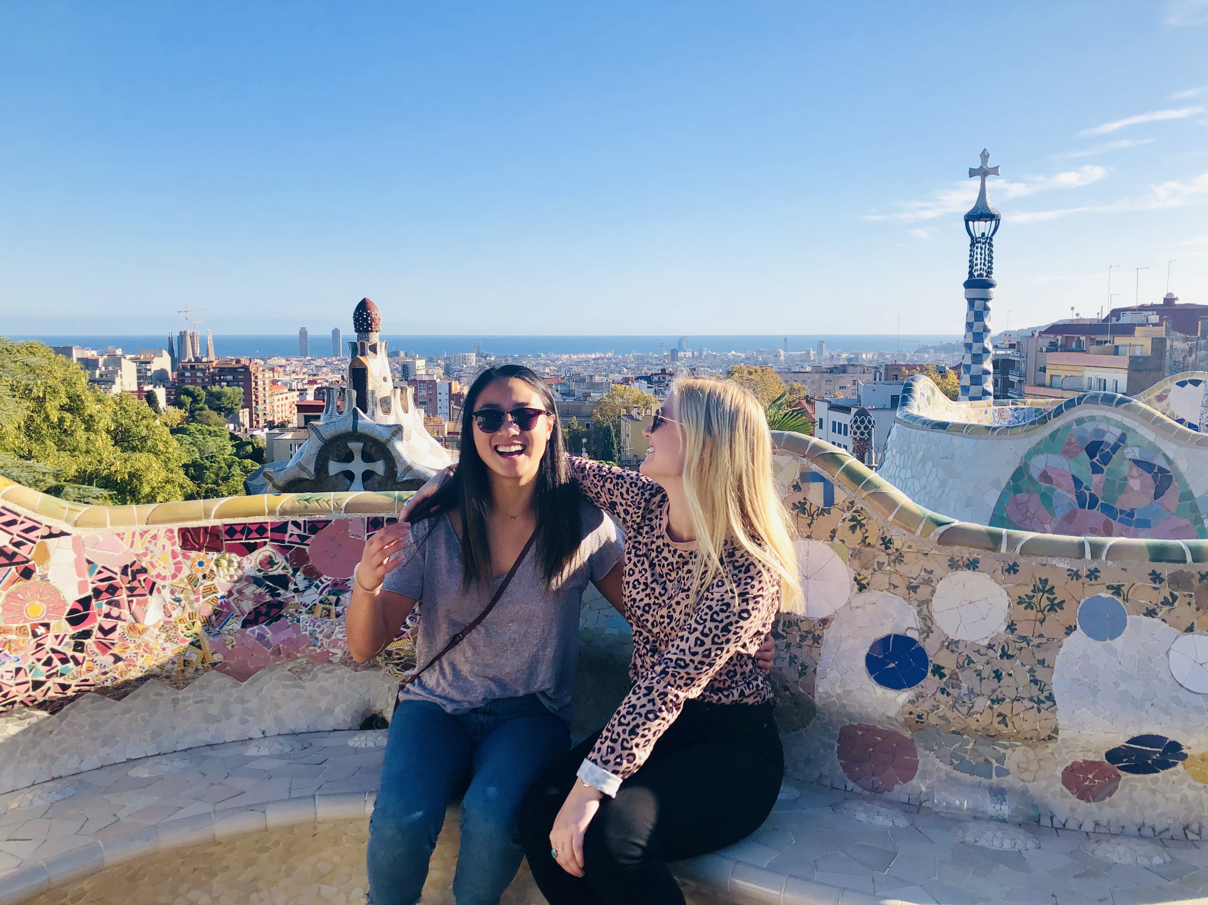 Sitting against the wall in Park Guell in Barcelona 