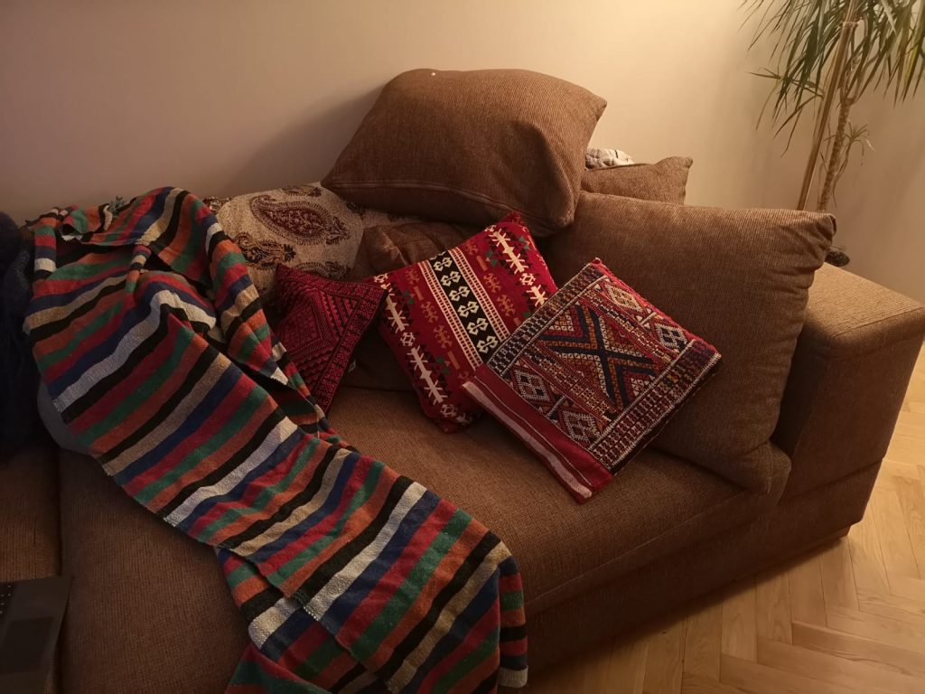 Helen's couch with colourful blankets and cushions