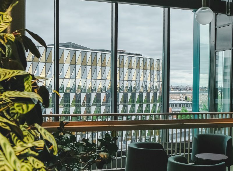 A view of Aula Medica through the window of a neighboring building