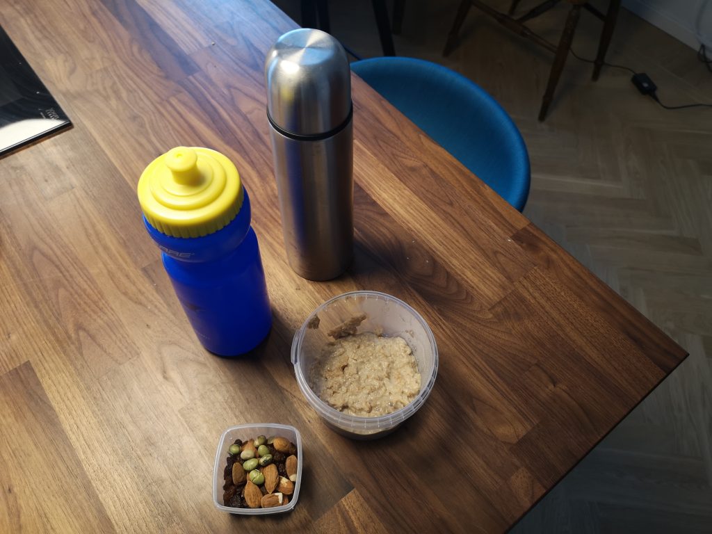 My food setup before rushing to KI. An empty bottle for water, a thermos of hot green tea, leftover breakfast and sultanas, nuts & edamame beans for snacks.
