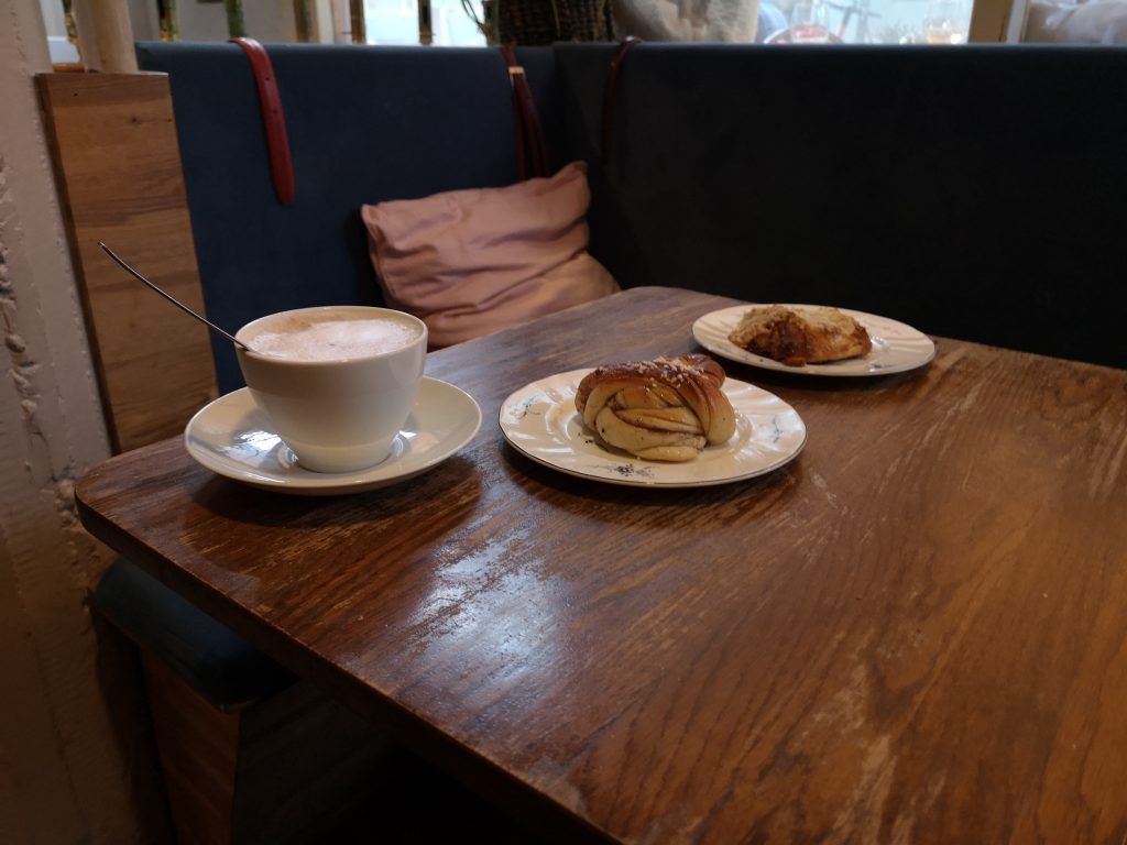 a cinnamon bun, an almond croissant and coffee