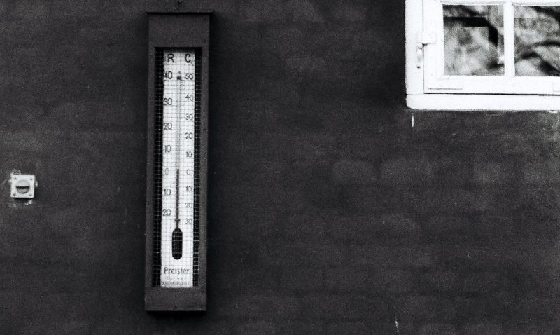 A thermometer on a black wall. A play on the words 