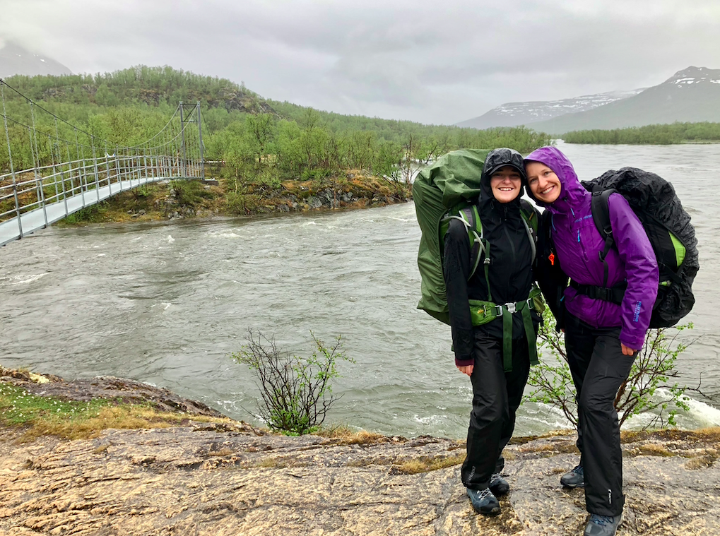 Dressed in rain gear in front of a river