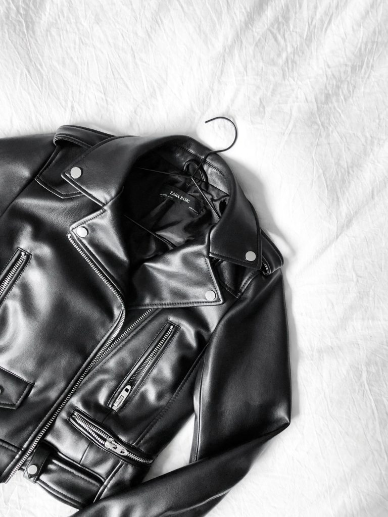 A black leather jacket on a white sheet