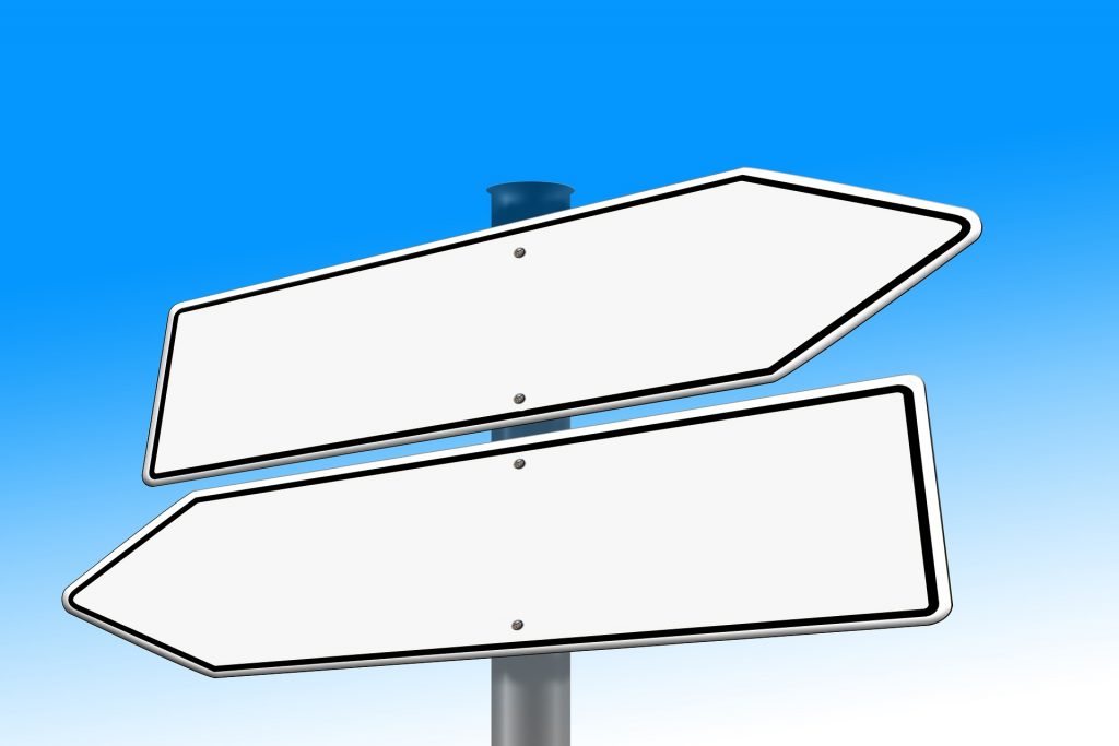 Signs pointing different directions, as if at a crossroads