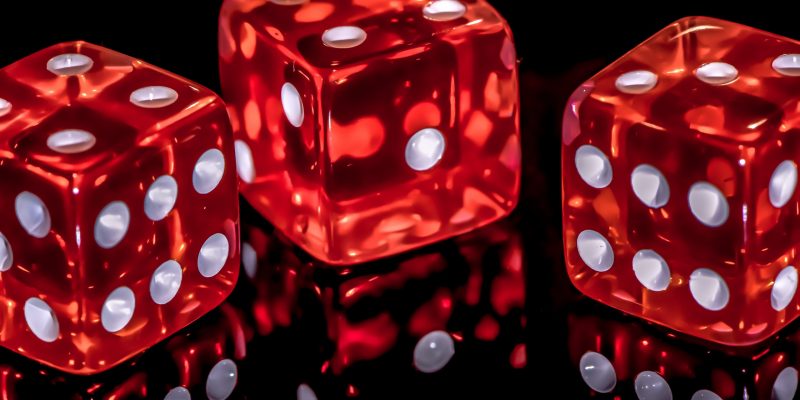 Shiny red dice on a black background