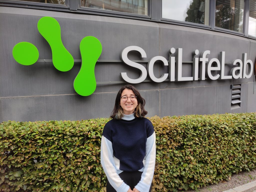 Yağmur a student from Turkey, standing in front of the SciLifeLab building