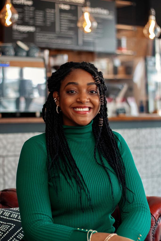 Kelma, a student from St. Lucia in a coffee shop.