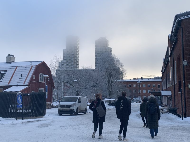 Three students walking in the snow