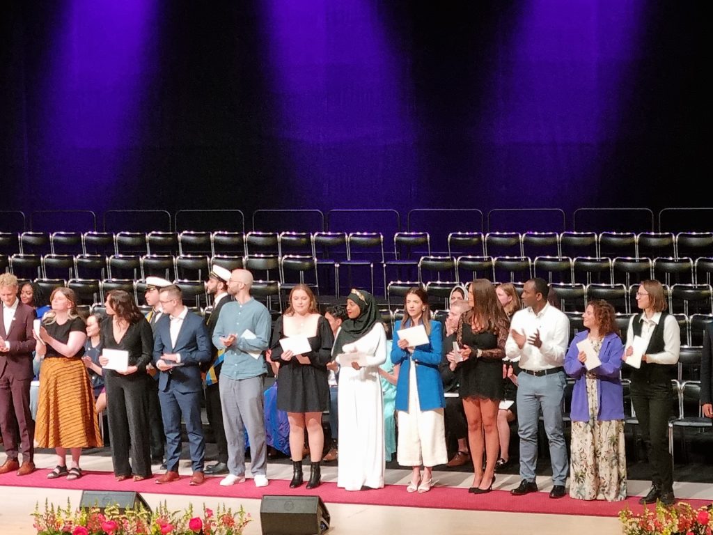 The global health class on the stage on graduation day.
