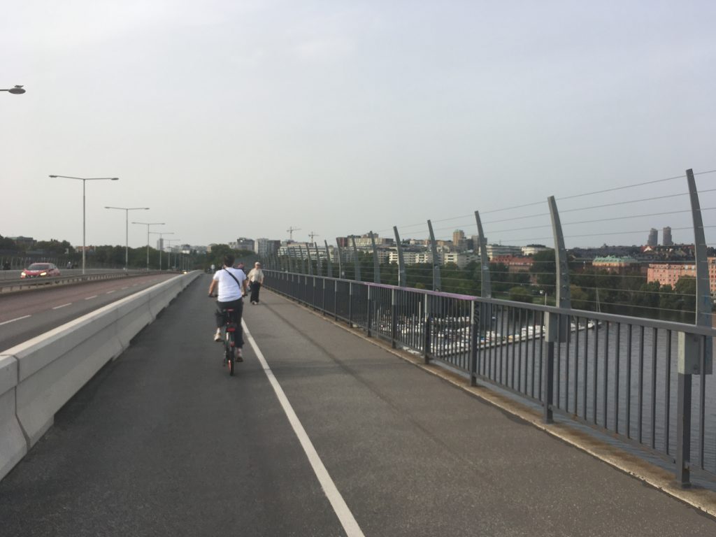 A photo of a cyclist on a bridge in Sweden