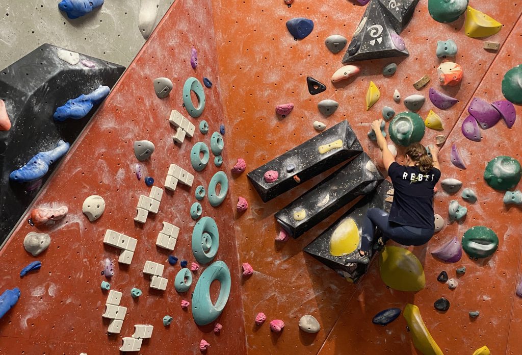 Photo of a girl on a climbing wall