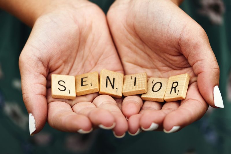 Hands-holding letters that read SENIOR showing growth and career planning