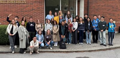 Group photo in front of brick wall