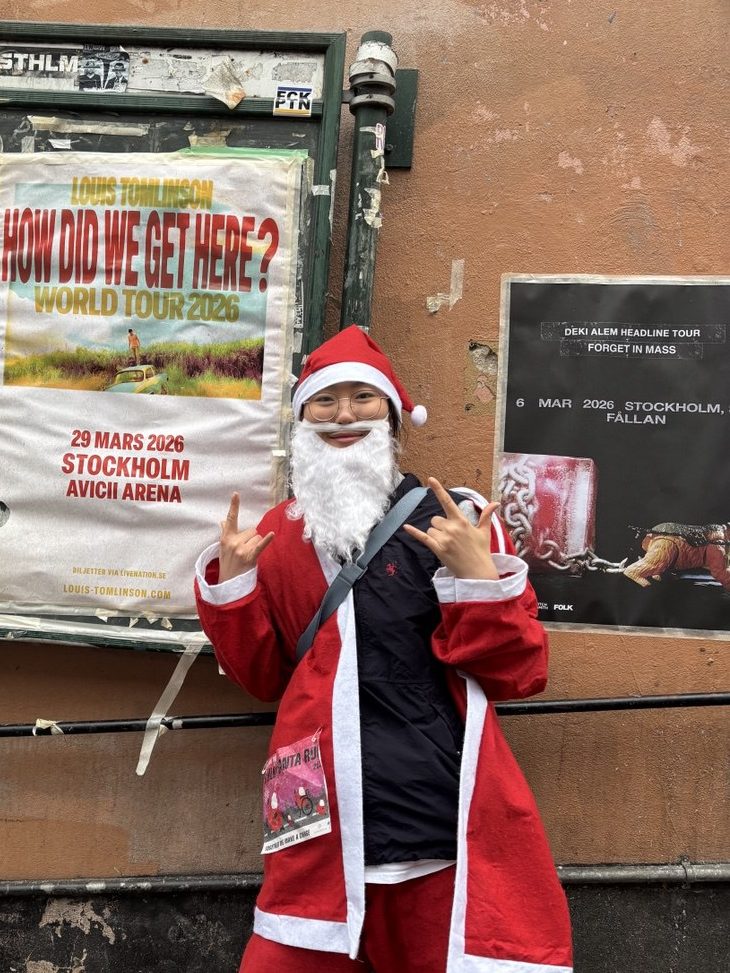 A girl in a Santa costume posing.