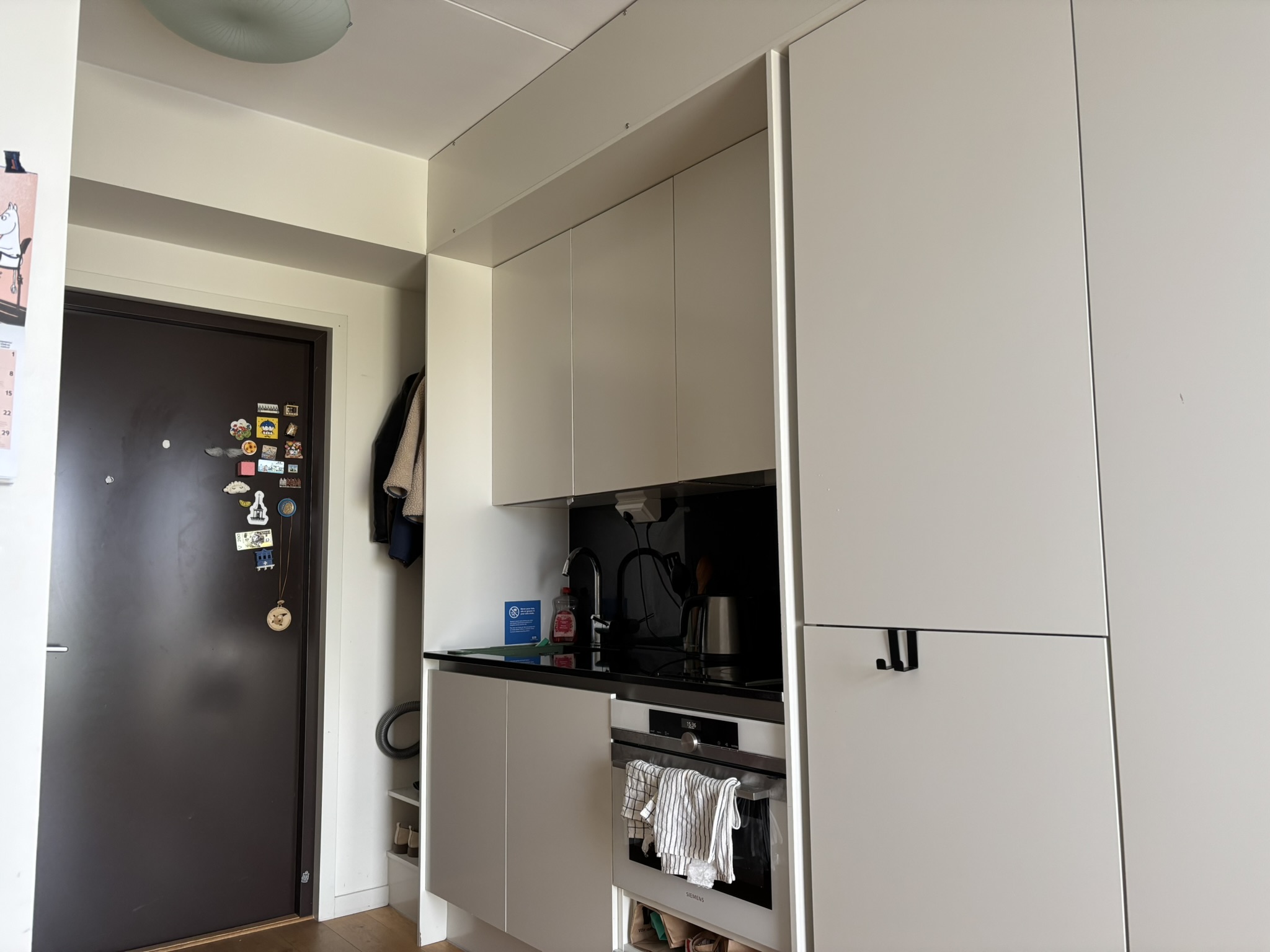 A small kitchenette with an oven, countertop induction stove.