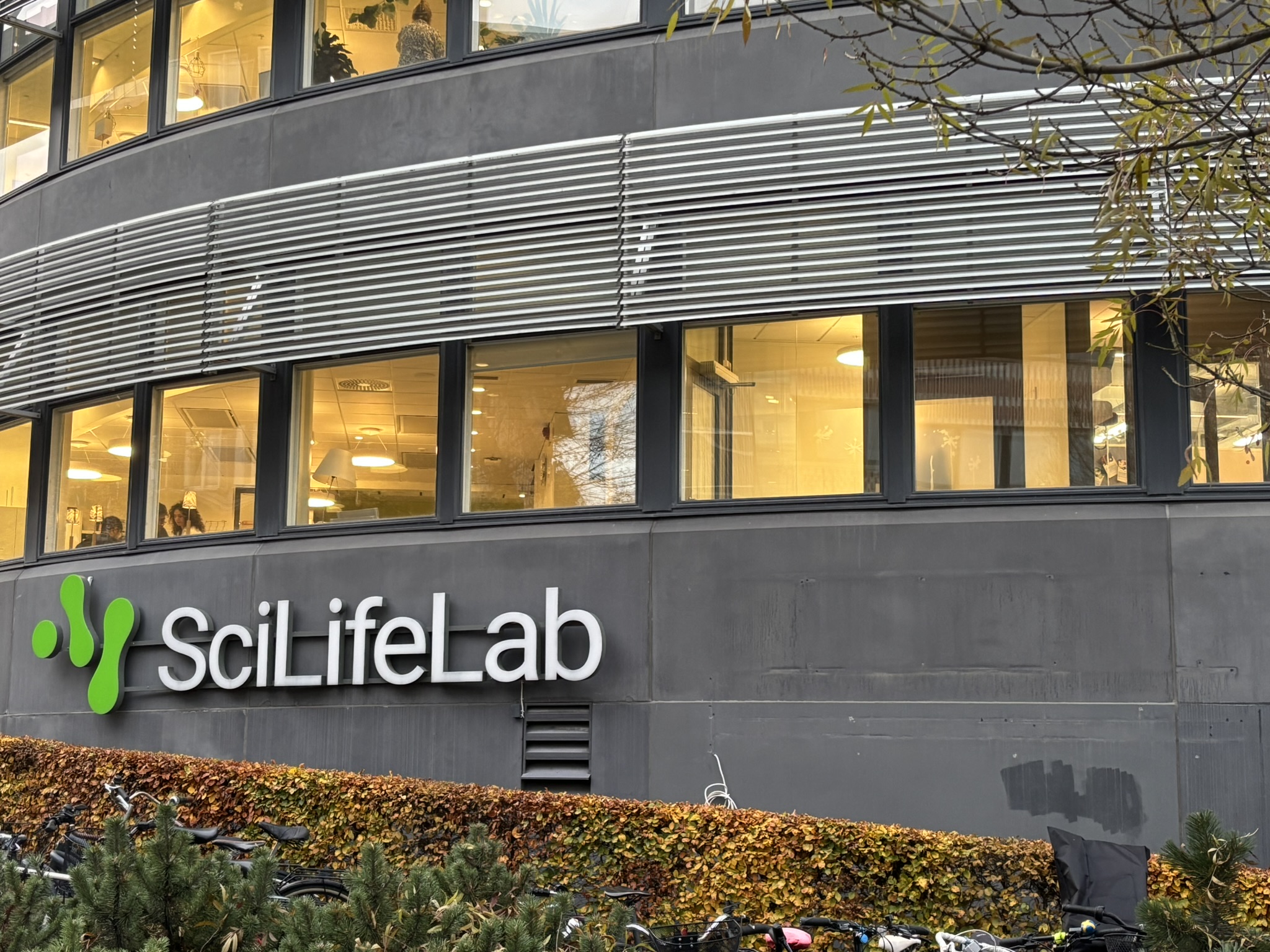 A view of the lowest floor of a large building with awindows spanning across the building. The logo says "SciLifeLab"